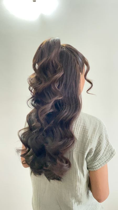 Long brunette hair in bouncy, defined curls