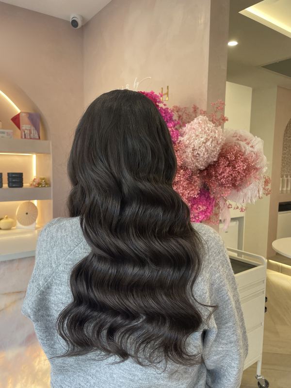 Deep, glossy Hollywood waves on long dark hair