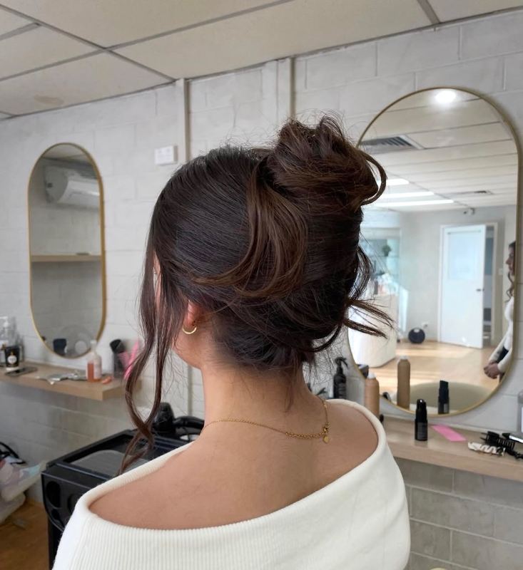Textured high bun with soft face framing pieces