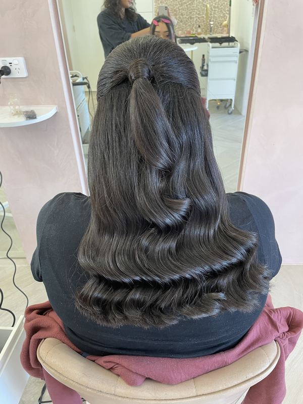 Half up style with sculpted, glossy Hollywood waves