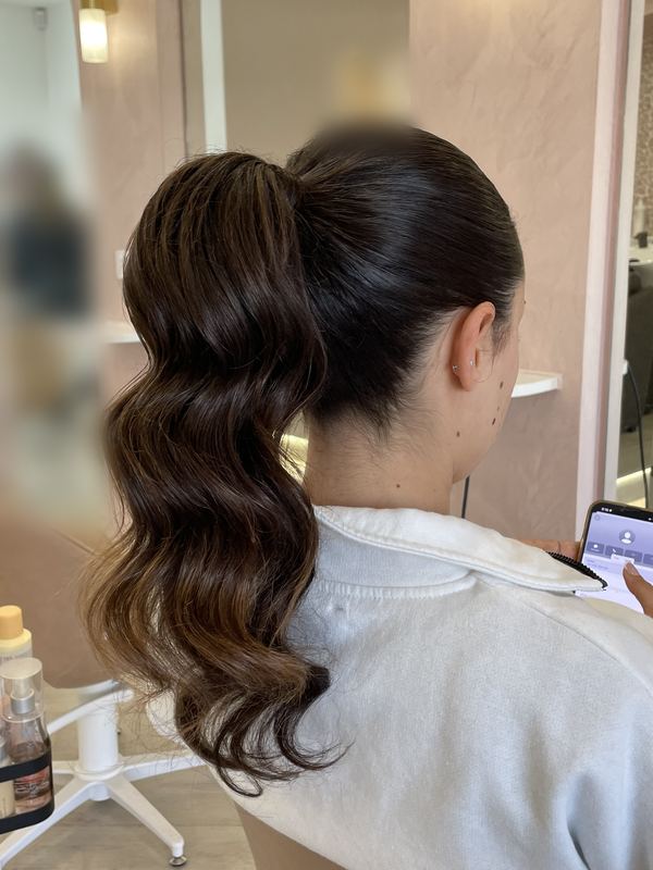 High sleek ponytail with long bouncy waves