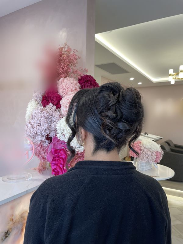Soft, romantic curled updo with loose pieces