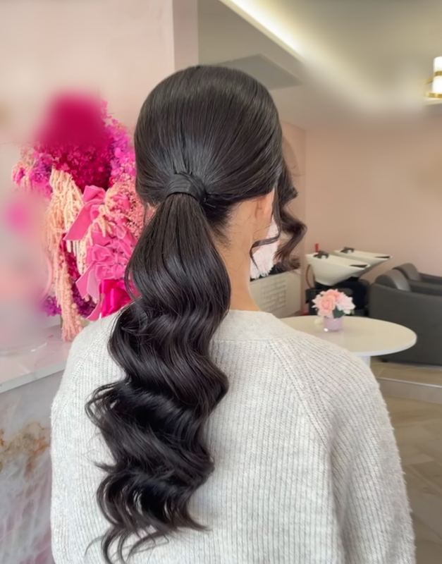 Low ponytail with long sculpted waves